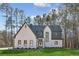 Two-story modern farmhouse with white brick and dark gray accents, landscaped lawn at 1820 Lake Dow Rd, Mcdonough, GA 30252
