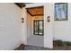 Covered front entry with brick facade, glass door, and modern light fixtures at 1820 Lake Dow Rd, Mcdonough, GA 30252