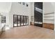 Living area with floor to ceiling fireplace, multi-panel doors to backyard, and kitchen at 1820 Lake Dow Rd, Mcdonough, GA 30252