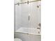 Modern tub and shower with glass doors and bronze fixtures at 1820 Lake Dow Rd, Mcdonough, GA 30252