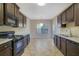 Kitchen with dark brown cabinets, granite counters and black appliances at 2686 Caleb James Rd, Marietta, GA 30064