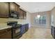 Modern kitchen with dark cabinets, granite counters and black appliances at 2686 Caleb James Rd, Marietta, GA 30064