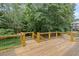 Wide-angle of wooden back deck overlooking green backyard. Features wooden rails and metal wire at 641 Virginia Ave, Suwanee, GA 30024