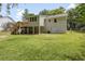 Backyard view of house showing a walkout basement, large yard, and wooden deck with stairs at 641 Virginia Ave, Suwanee, GA 30024