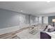 Finished basement with white trim, hardwood flooring, and stylish furniture, lit by recessed and lamp lighting at 641 Virginia Ave, Suwanee, GA 30024