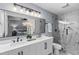 Stylish bathroom boasts double sink vanity, sleek lighting, and a glass shower enclosure at 641 Virginia Ave, Suwanee, GA 30024