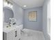 Well-lit bathroom with a round mirror, modern vanity, black faucet, and elegant wall art at 641 Virginia Ave, Suwanee, GA 30024