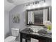 This bathroom has a unique bowl sink and dark granite counter on a black vanity cabinet at 641 Virginia Ave, Suwanee, GA 30024