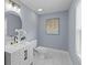 Stylish powder room featuring a modern vanity, round mirror, and elegant fixtures at 641 Virginia Ave, Suwanee, GA 30024