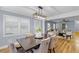 Open concept dining room featuring a wooden table, plush chairs, and decorative lighting at 641 Virginia Ave, Suwanee, GA 30024