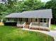 Inviting home featuring a cozy front porch, fresh landscaping, and a well-kept green lawn at 641 Virginia Ave, Suwanee, GA 30024