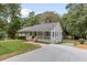 Charming home boasts a well-manicured front yard and long driveway, complemented by lush landscaping and mature trees at 641 Virginia Ave, Suwanee, GA 30024