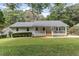 Charming home boasts a well-manicured front yard, complemented by lush landscaping and mature trees at 641 Virginia Ave, Suwanee, GA 30024