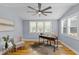 The home office is bright with lots of natural light and has a decorative ceiling fan at 641 Virginia Ave, Suwanee, GA 30024