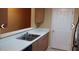 Kitchen with double sink, light wood cabinets and white countertops at 8101 Par Four Way, Lithonia, GA 30038