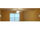 Bright living room with a ceiling fan and large window at 8101 Par Four Way, Lithonia, GA 30038