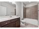 Neutral bathroom with a dark vanity with white sink, a toilet and a tub with shower at 4196 Morrison Way # 11, Atlanta, GA 30341
