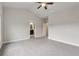 A spacious bedroom showcasing gray carpet, vaulted ceilings and doorway to a bathroom with dark vanity at 4196 Morrison Way # 11, Atlanta, GA 30341
