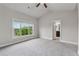 Bright bedroom with gray carpet, vaulted ceiling, a ceiling fan and a doorway to the bathroom at 4196 Morrison Way # 11, Atlanta, GA 30341