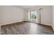 Bedroom featuring wood-look floors, large window with sheer curtains and neutral walls at 4196 Morrison Way # 11, Atlanta, GA 30341