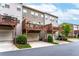Townhome's rear exterior featuring elevated decks over drive-under garages, landscaping, and mature trees at 4196 Morrison Way # 11, Atlanta, GA 30341