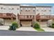 Townhome's rear exterior featuring elevated decks over drive-under garages; three units depicted at 4196 Morrison Way # 11, Atlanta, GA 30341