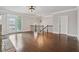 Bright foyer featuring hardwood floors, fireplace, staircase, French doors, and modern light fixtures at 4196 Morrison Way # 11, Atlanta, GA 30341