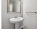 Cozy half-bathroom featuring a pedestal sink, a towel bar and modern mirror at 4196 Morrison Way # 11, Atlanta, GA 30341