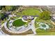 An aerial view shows a beautifully designed park with walking paths, green spaces, and playground areas at 812 Stratford Rd, Avondale Estates, GA 30002