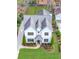 Aerial view of a pristine white two-story home with lush landscaping, a driveway, and a well-maintained lawn at 812 Stratford Rd, Avondale Estates, GA 30002