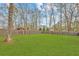 Expansive backyard with a large, grassy lawn, mature trees, and a privacy fence at 812 Stratford Rd, Avondale Estates, GA 30002
