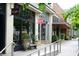 Charming bakery exterior with large windows, outdoor seating, and lush greenery along a sidewalk at 812 Stratford Rd, Avondale Estates, GA 30002