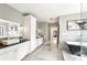 Modern bathroom with sleek vanity, a soaking tub, stylish tile, and plenty of storage at 812 Stratford Rd, Avondale Estates, GA 30002