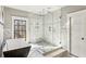 Bright bathroom featuring a glass-enclosed shower, freestanding tub, and modern fixtures, showcasing a luxurious design at 812 Stratford Rd, Avondale Estates, GA 30002