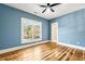 Bright bedroom featuring hardwood floors, a ceiling fan, and a large window, offering a comfortable and relaxing ambiance at 812 Stratford Rd, Avondale Estates, GA 30002