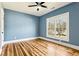 Inviting bedroom with a ceiling fan, hardwood floors, and a sunlit window, creating a cozy and airy space at 812 Stratford Rd, Avondale Estates, GA 30002