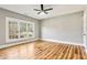 Spacious bedroom featuring hardwood floors, a ceiling fan, and natural light from a window, offering comfort and style at 812 Stratford Rd, Avondale Estates, GA 30002