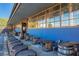 Outdoor beer garden featuring blue wall, barrels, and tables for a relaxed and inviting neighborhood atmosphere at 812 Stratford Rd, Avondale Estates, GA 30002