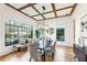 Bright dining room with wood floors, coffered ceilings, a wooden bench, and large windows at 812 Stratford Rd, Avondale Estates, GA 30002