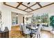 Inviting dining room with coffered ceiling, modern lighting fixture, and large windows that offer a scenic view at 812 Stratford Rd, Avondale Estates, GA 30002