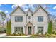 Inviting two-story home showcasing a stone entrance, brick facade, large windows and meticulously landscaped front yard at 812 Stratford Rd, Avondale Estates, GA 30002