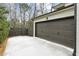 Exterior view of a white brick home featuring a two-car garage and a paved driveway at 812 Stratford Rd, Avondale Estates, GA 30002