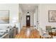 Hallway view with front door, hardwood floors, and view into living room at 812 Stratford Rd, Avondale Estates, GA 30002