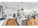 Bright kitchen with stainless appliances, white cabinets, granite counters and hardwood floors throughout at 812 Stratford Rd, Avondale Estates, GA 30002