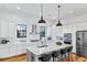 Modern kitchen featuring granite countertops, stainless steel appliances, a large island, and stylish seating at 812 Stratford Rd, Avondale Estates, GA 30002
