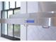 Close-up of the modern kitchen hood, complemented by a stylish tile backsplash and natural light from the window at 812 Stratford Rd, Avondale Estates, GA 30002