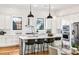 Bright kitchen with stainless appliances, white cabinets, granite counters, black accents and hardwood floors at 812 Stratford Rd, Avondale Estates, GA 30002