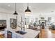 Bright kitchen with stainless appliances, white cabinets, granite counters, open to living room at 812 Stratford Rd, Avondale Estates, GA 30002
