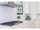 Gourmet kitchen featuring a professional gas range, custom hood, and sleek countertops; perfect for cooking at 812 Stratford Rd, Avondale Estates, GA 30002
