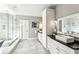 Luxurious bathroom features a glass-enclosed shower, tiled floors, and dual vanities with white cabinets at 812 Stratford Rd, Avondale Estates, GA 30002